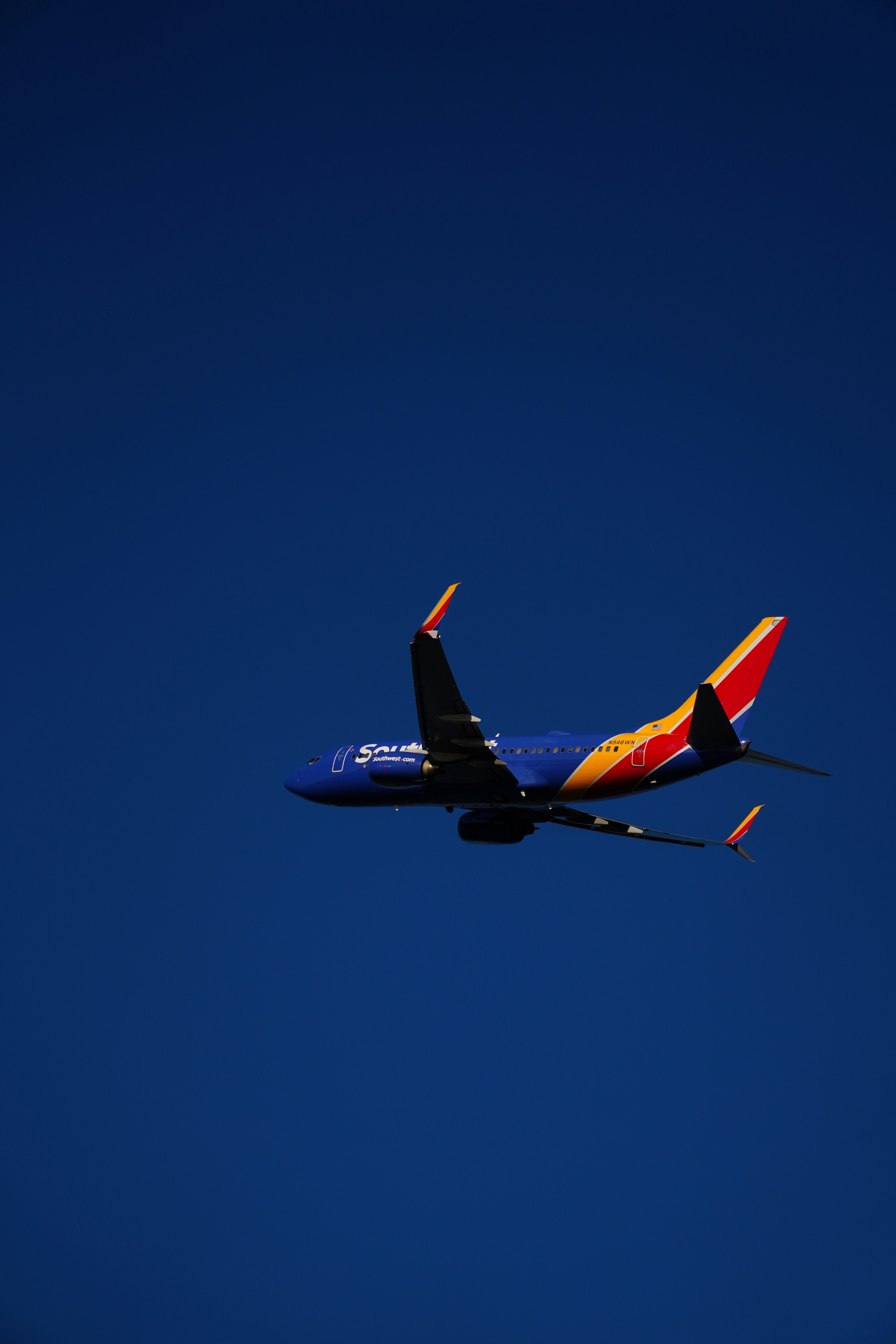 a large jetliner flying through a blue sky