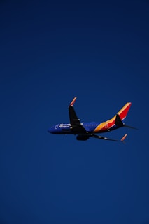 a large jetliner flying through a blue sky