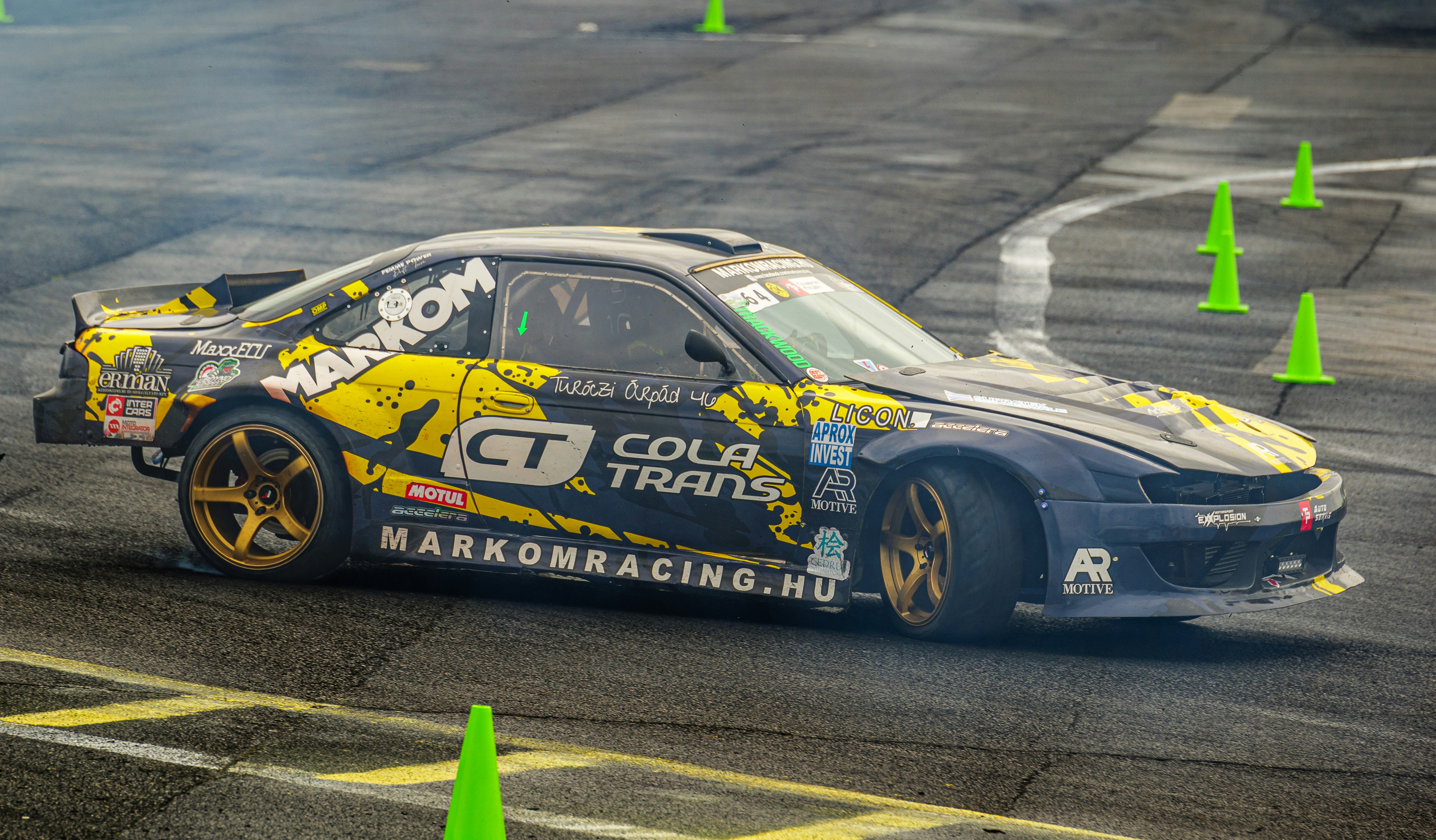 A racing car is turning around on a track photo – Free Car Image on ...