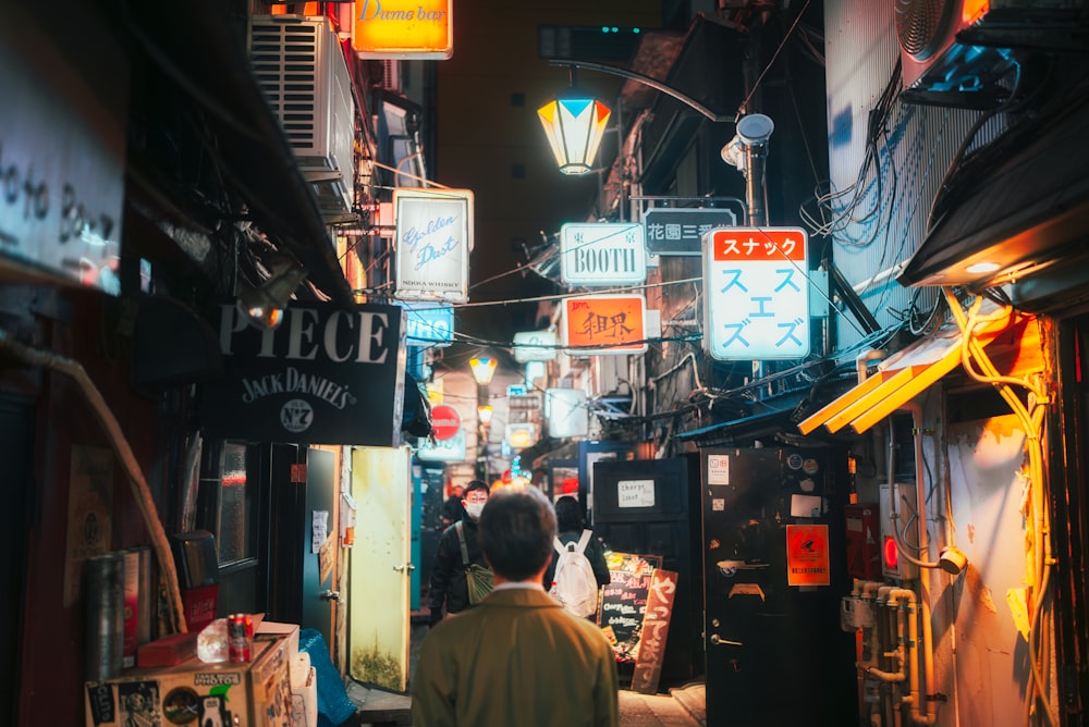 a person walking down a street at night