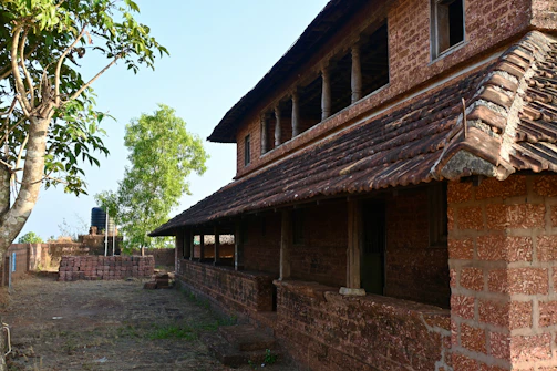 a brick building with a tree in front of it