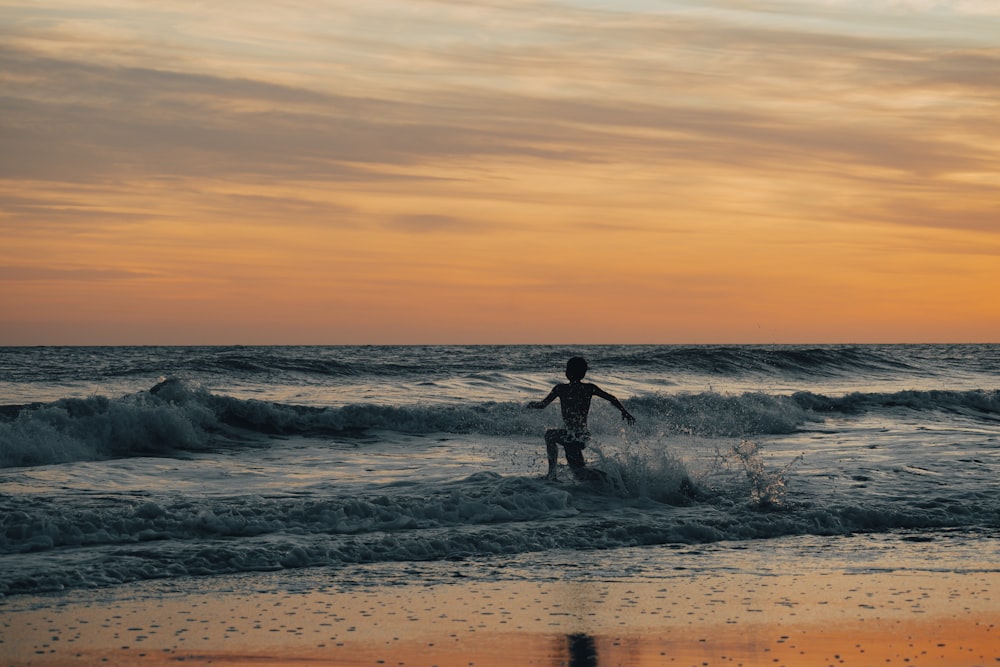 a person standing on a surfboard in the ocean