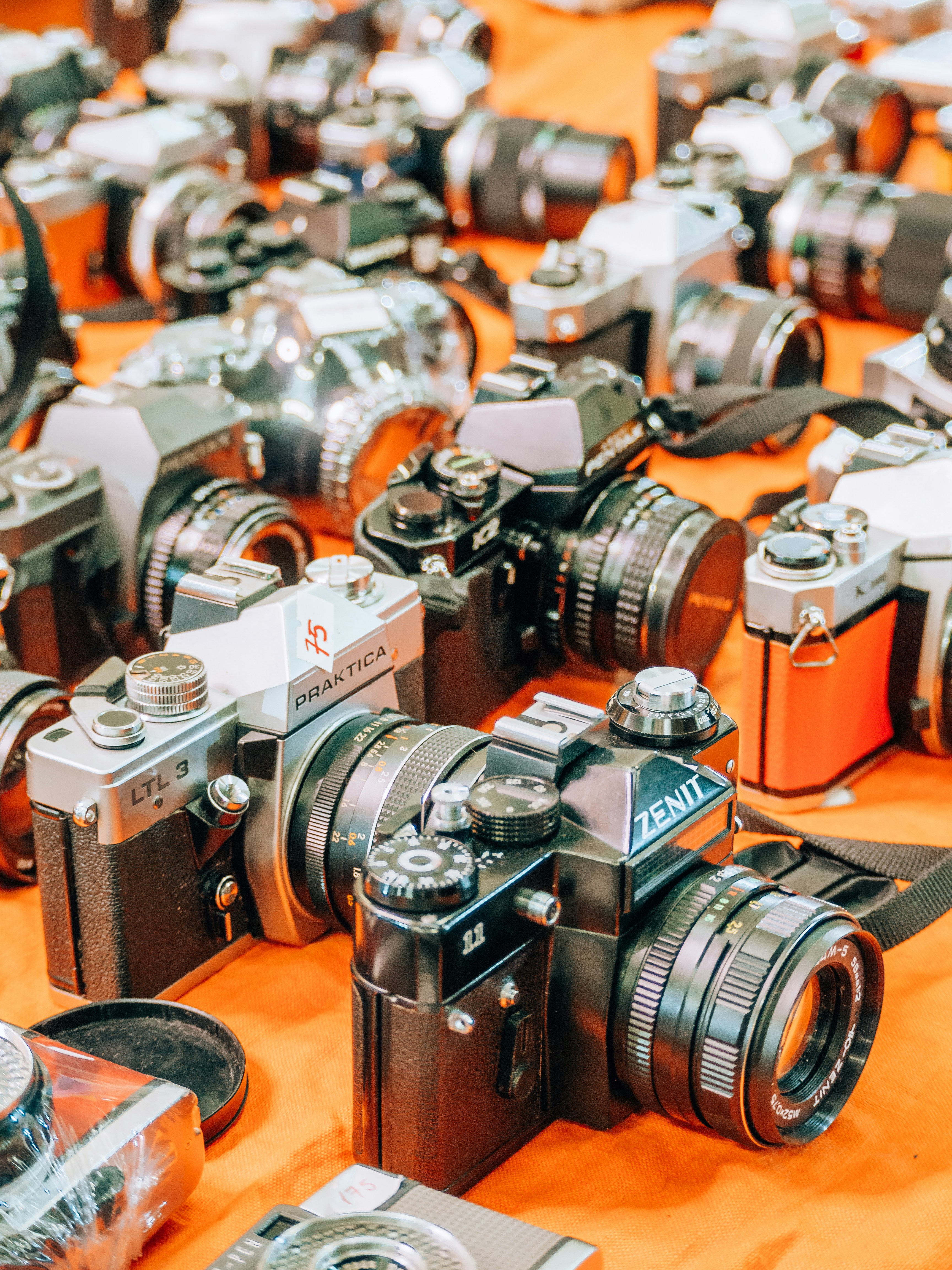 a table topped with lots of different types of cameras