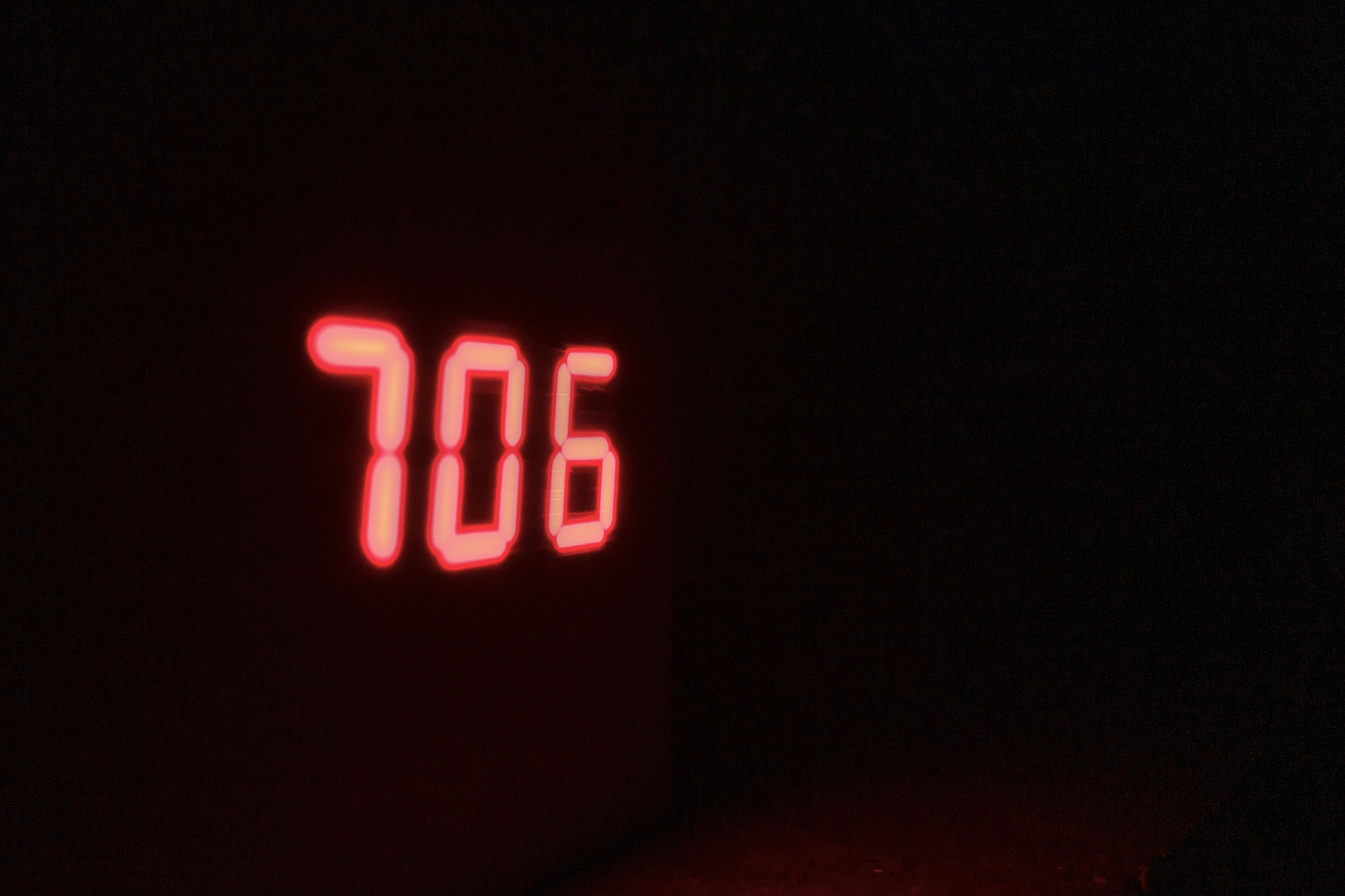a close up of a clock in the dark