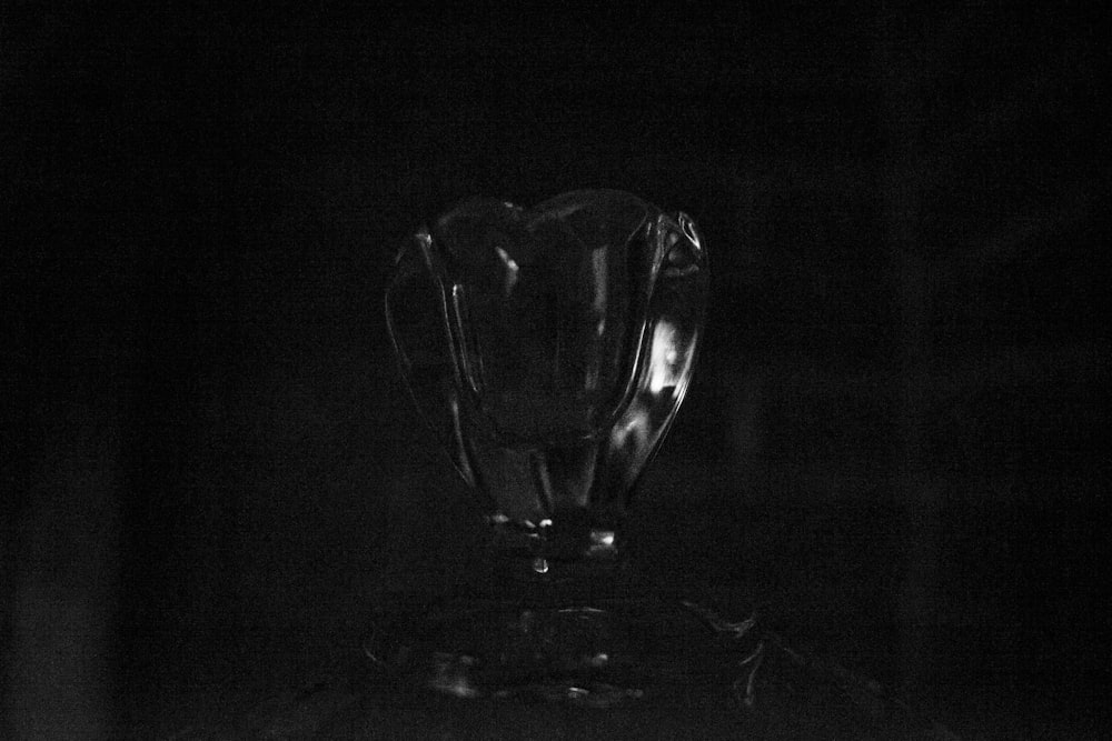 a glass vase sitting on top of a table