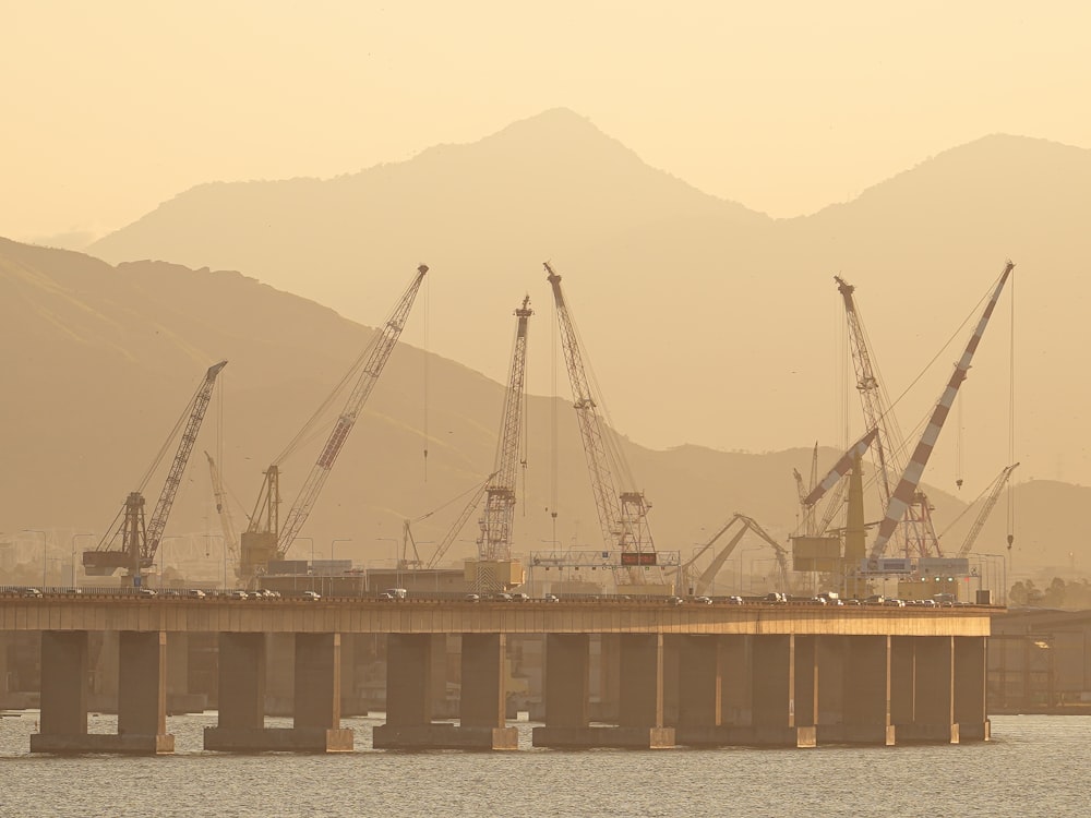 a bridge that has some cranes on top of it