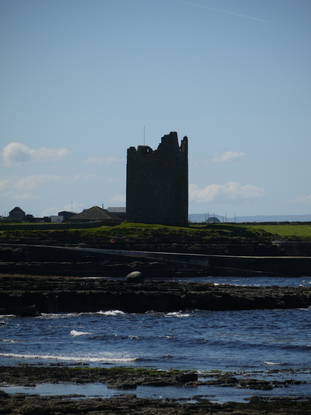 a large castle sitting on top of a lush green field