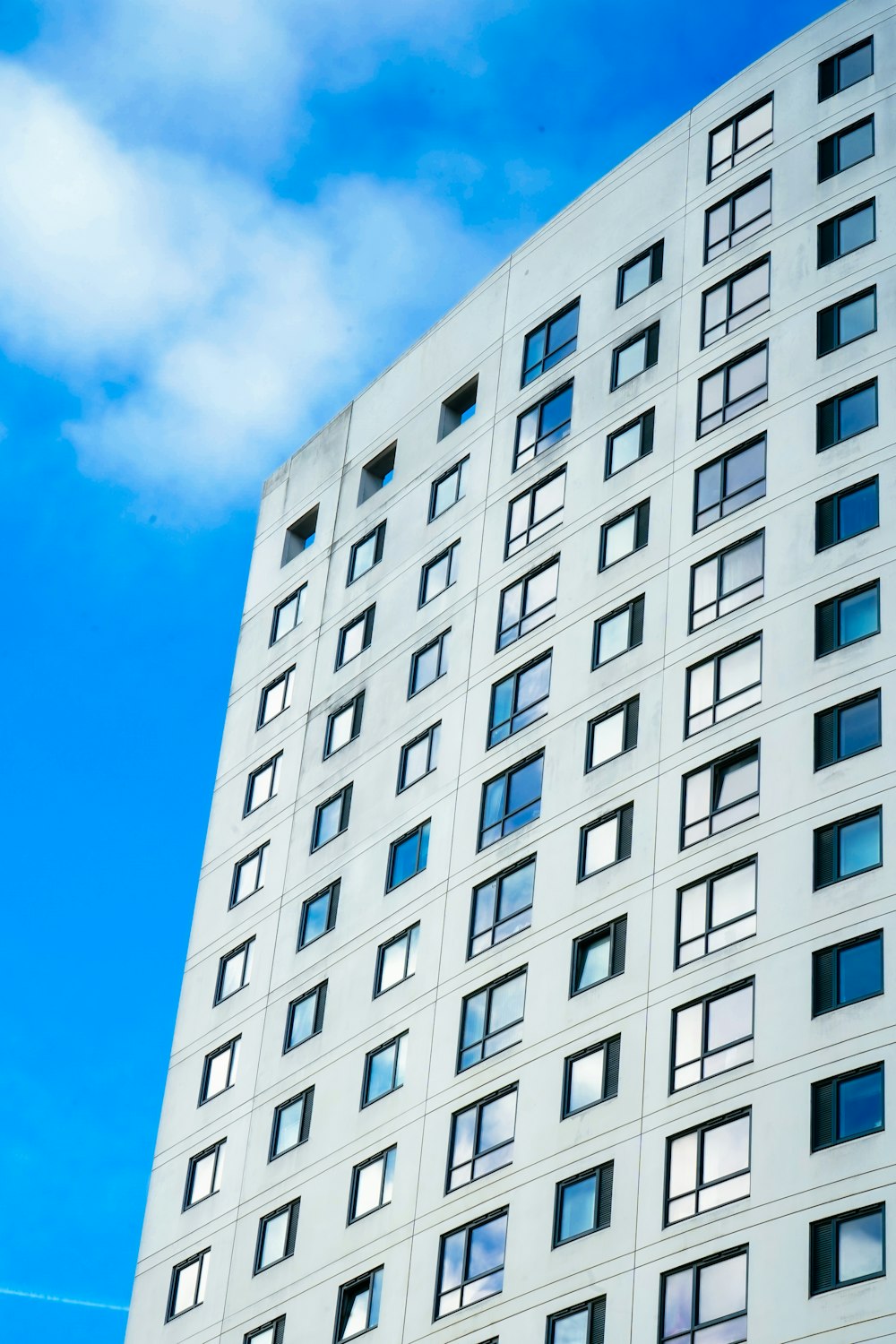 a tall white building with lots of windows