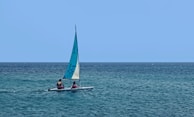 a couple of people on a small boat in the ocean