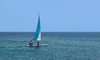 a couple of people on a small boat in the ocean