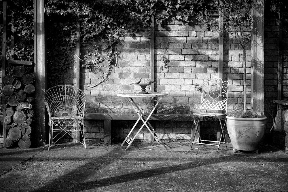 a black and white photo of two chairs and a table