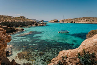 a boat is in the clear blue water