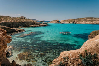 a boat is in the clear blue water