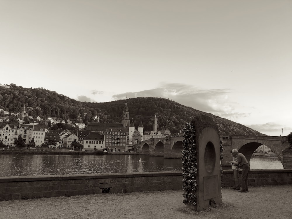 a black and white photo of a bridge over a river