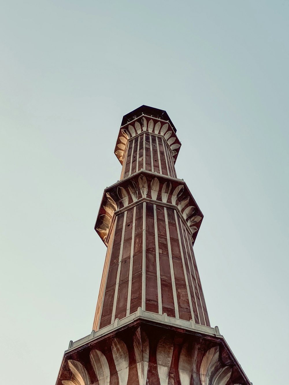 a tall tower with a clock on the top of it