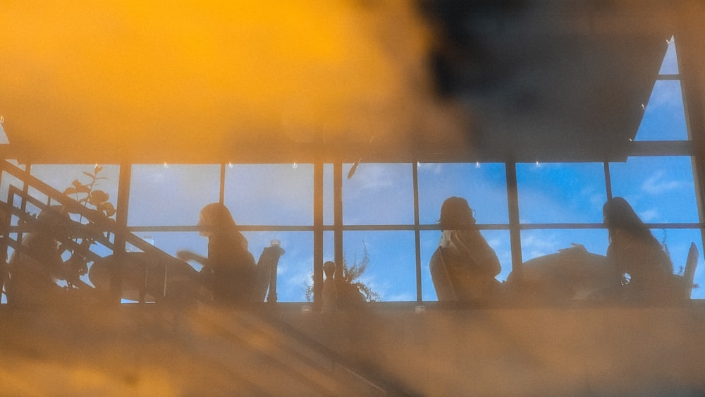 a group of people standing in front of a window