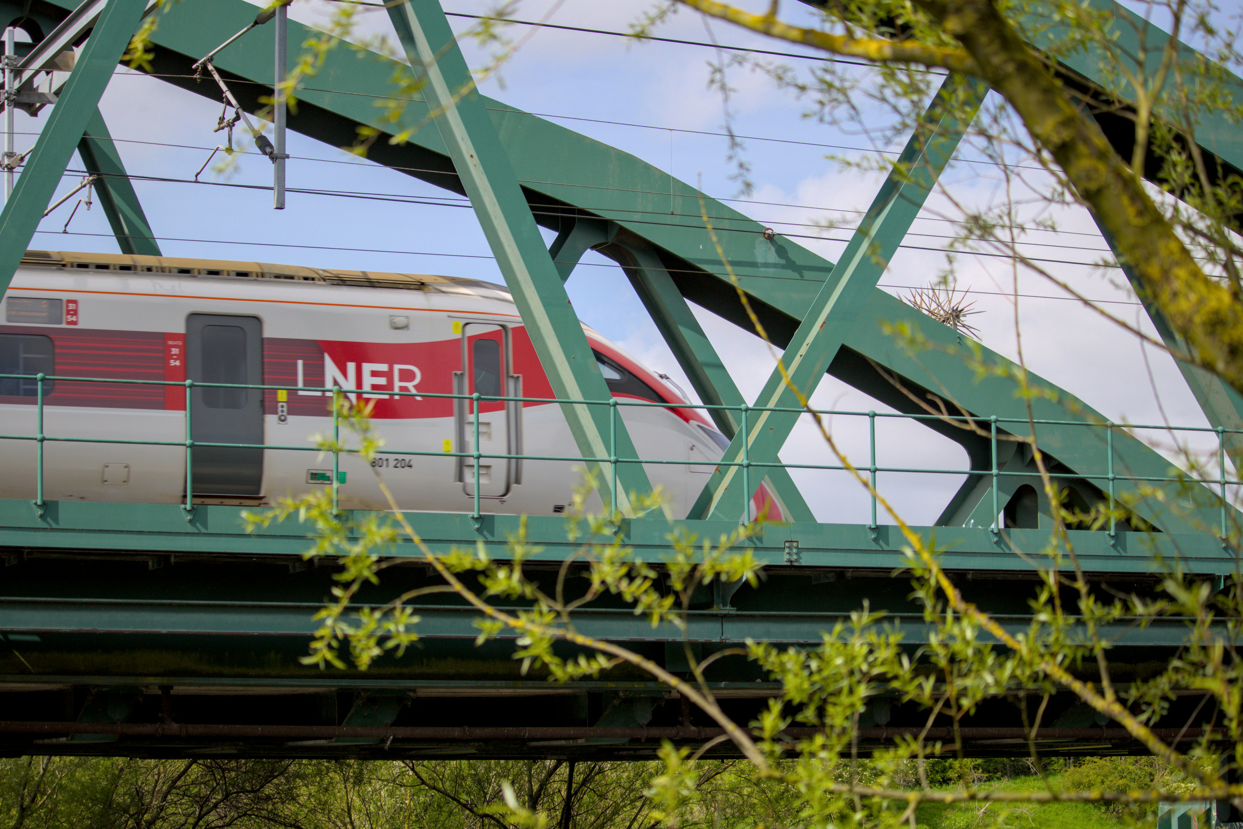 a train traveling over a bridge with a sky background
