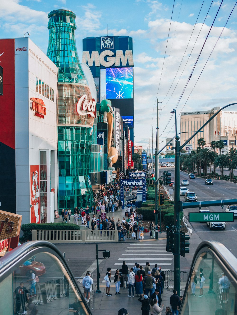 a crowd of people walking down a street next to tall buildings