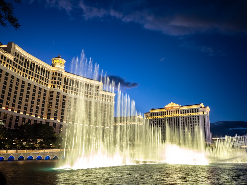 a large fountain in front of a large building