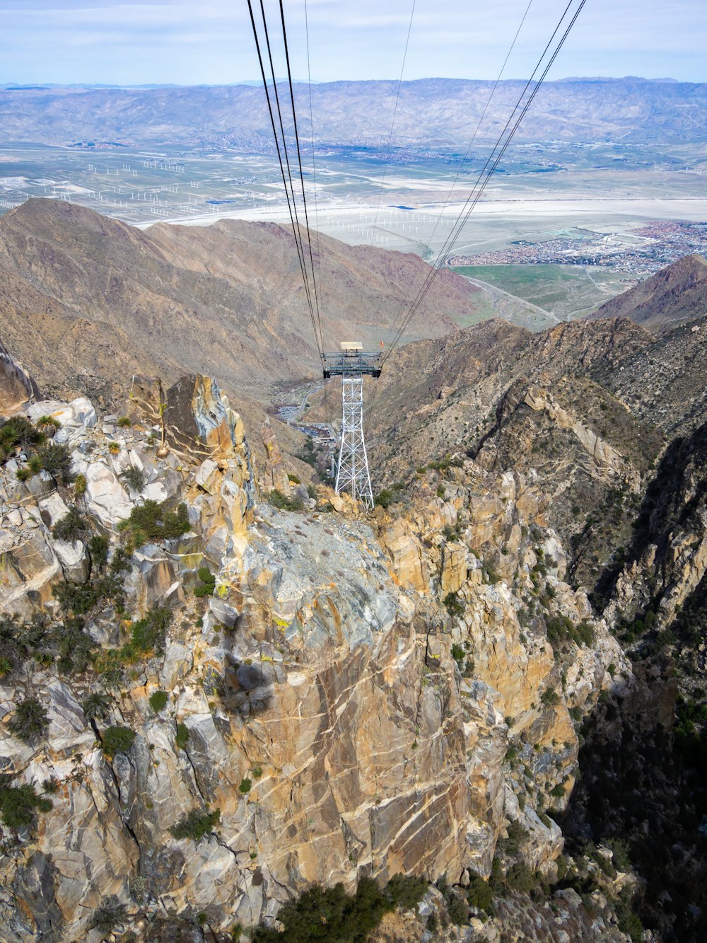 a cable car going over a mountain side