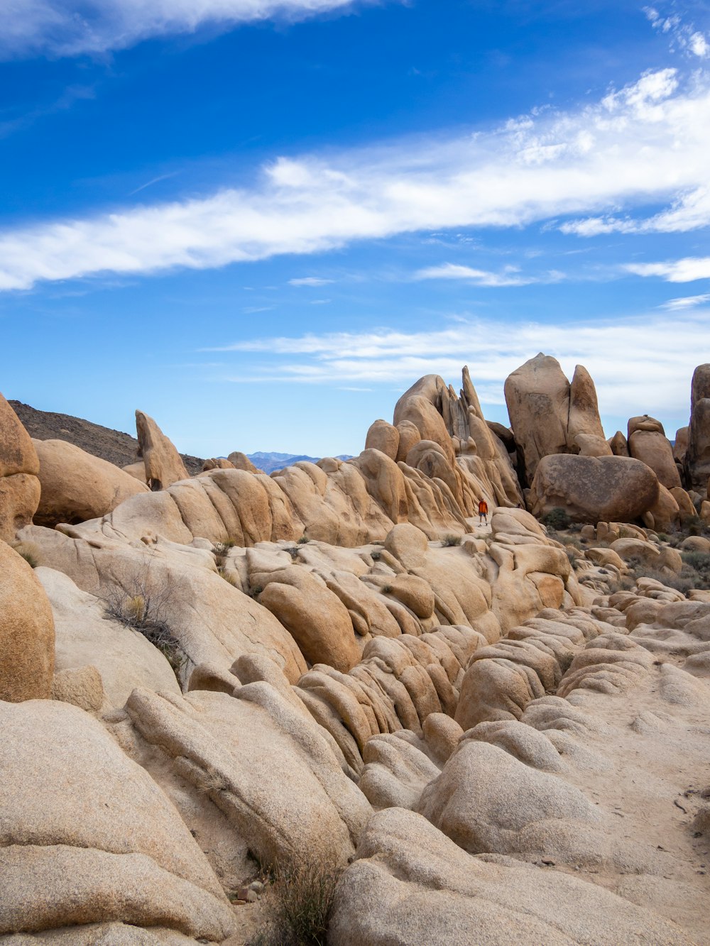 a person standing on top of a large rock formation