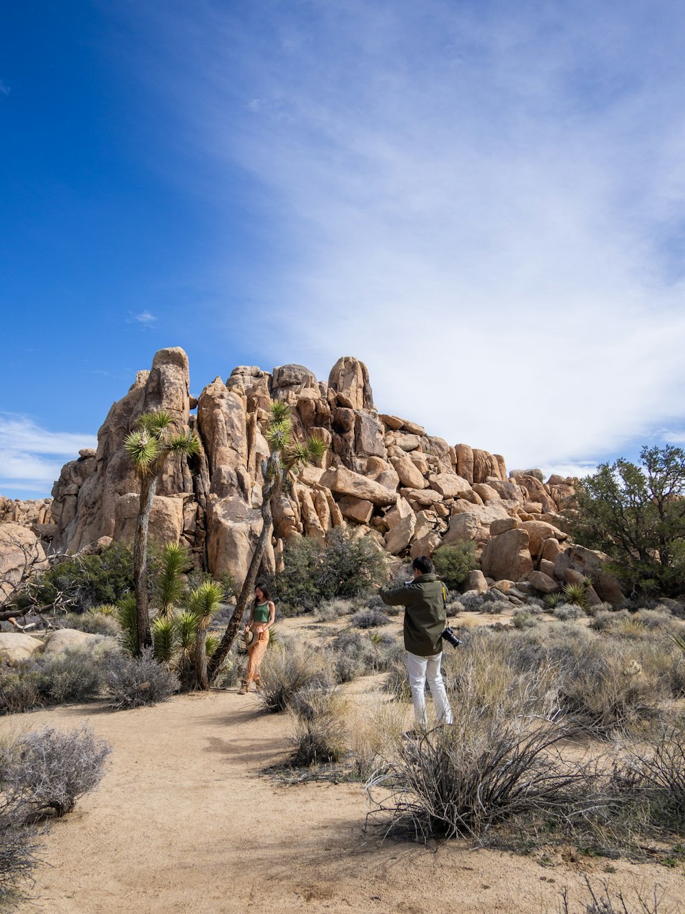 a man standing on top of a dirt road