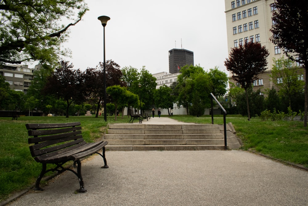 a wooden bench sitting in the middle of a park