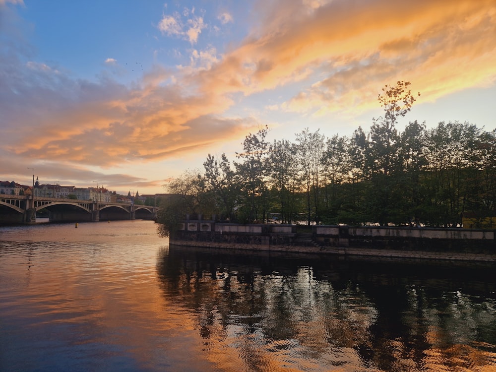 a river with a bridge in the background