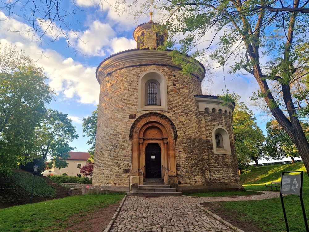 a stone building with a clock on the top of it