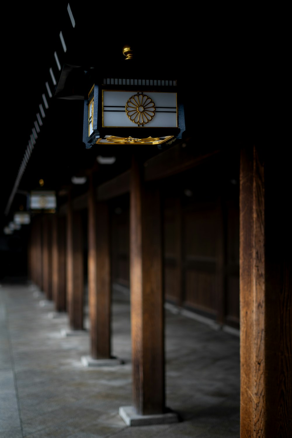 a row of wooden pillars with a clock on top