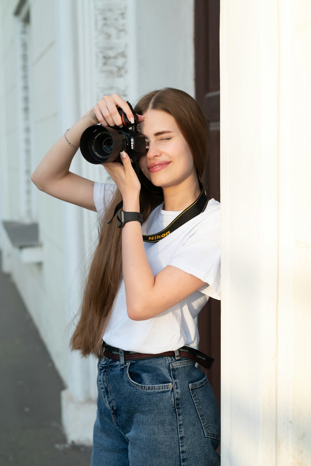 a woman taking a picture of herself with a camera