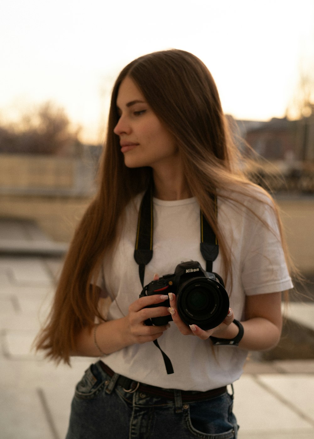 a woman with long hair holding a camera