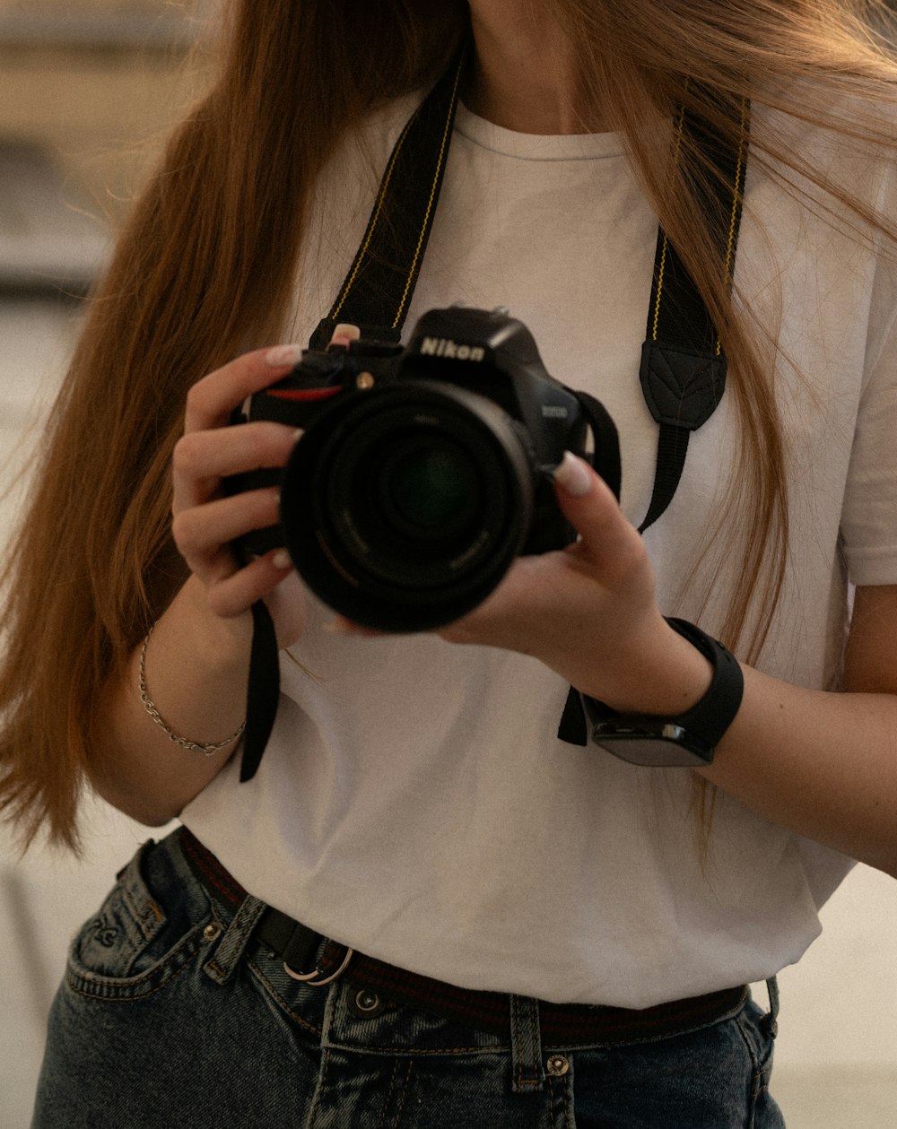 a woman holding a camera taking a picture