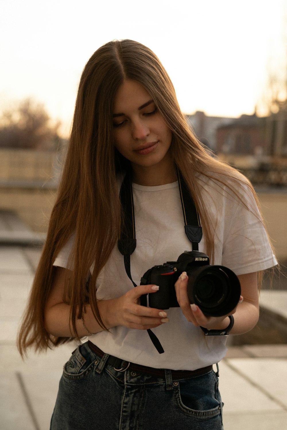 a woman with long hair holding a camera