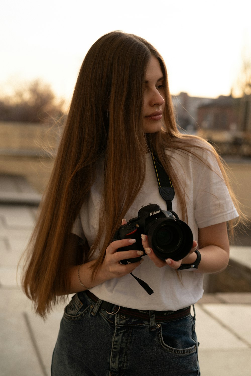 a woman with long hair holding a camera