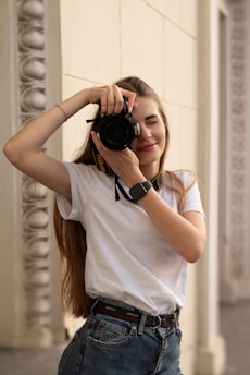 a woman taking a picture of herself with a camera