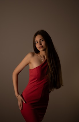 a woman in a red dress posing for a picture