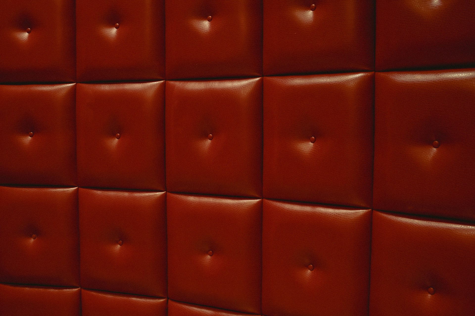 a close up of a wall made of red leather