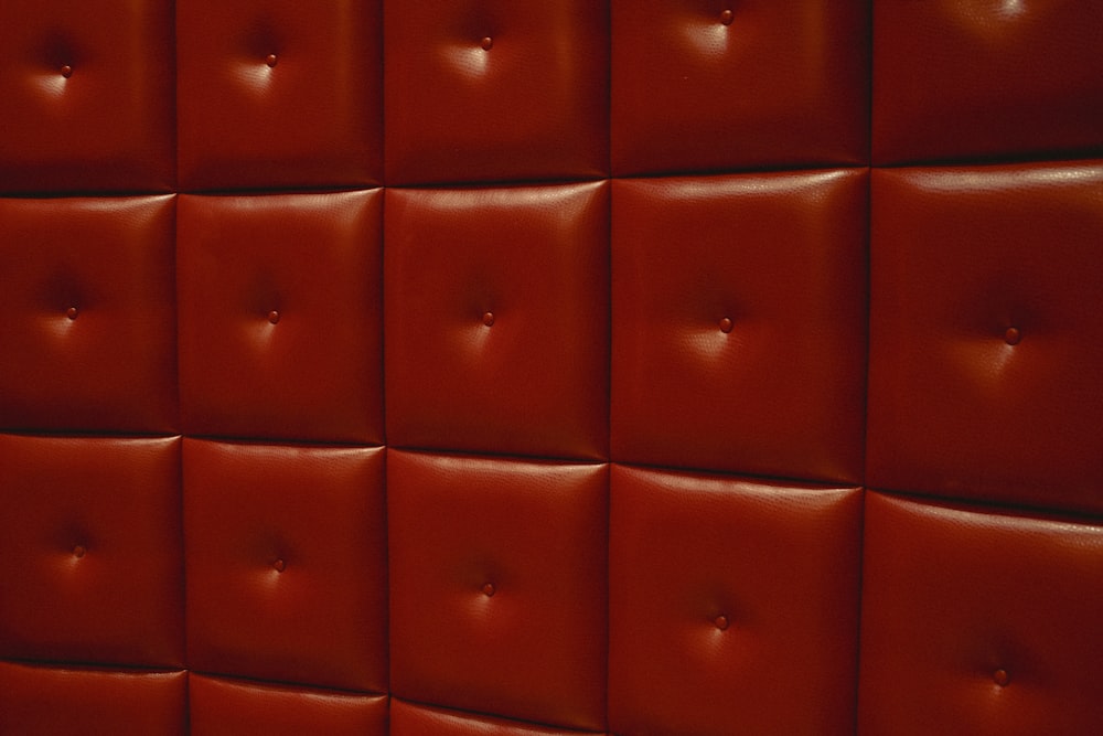 a close up of a wall made of red leather