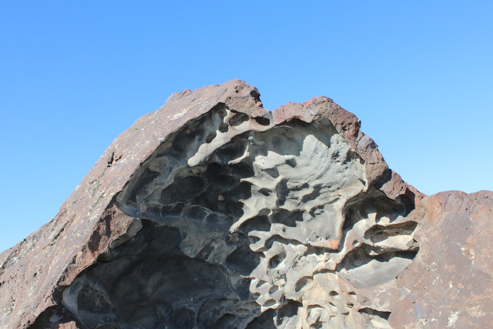 a rock formation with a blue sky in the background