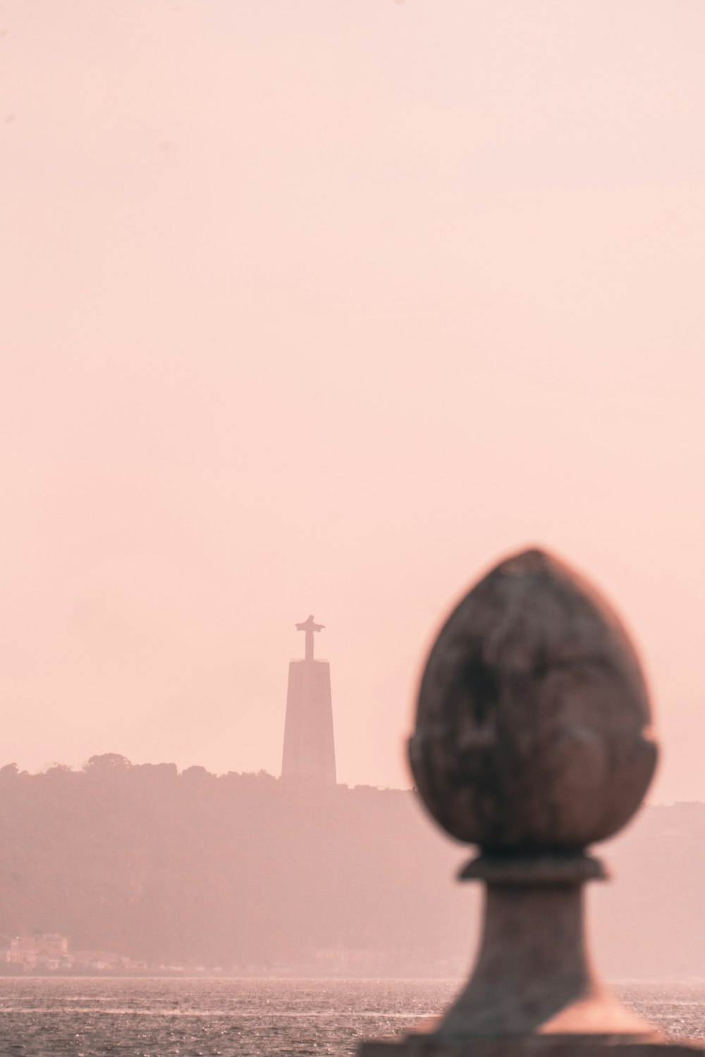 a view of a body of water with a cross in the background