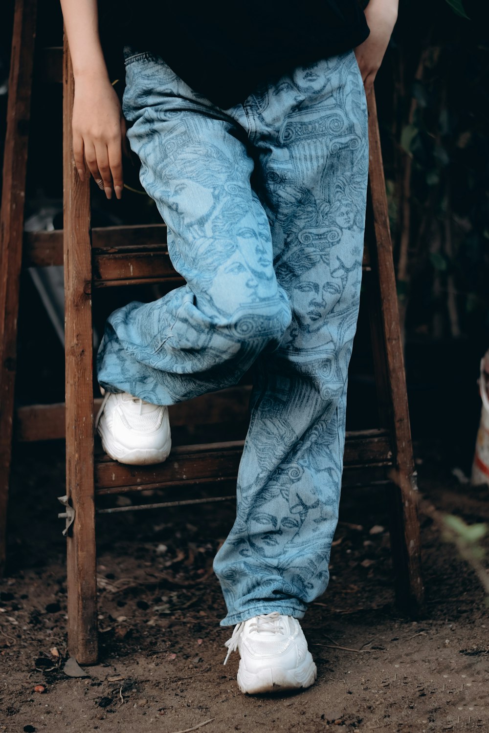 a person sitting on a chair with their legs crossed