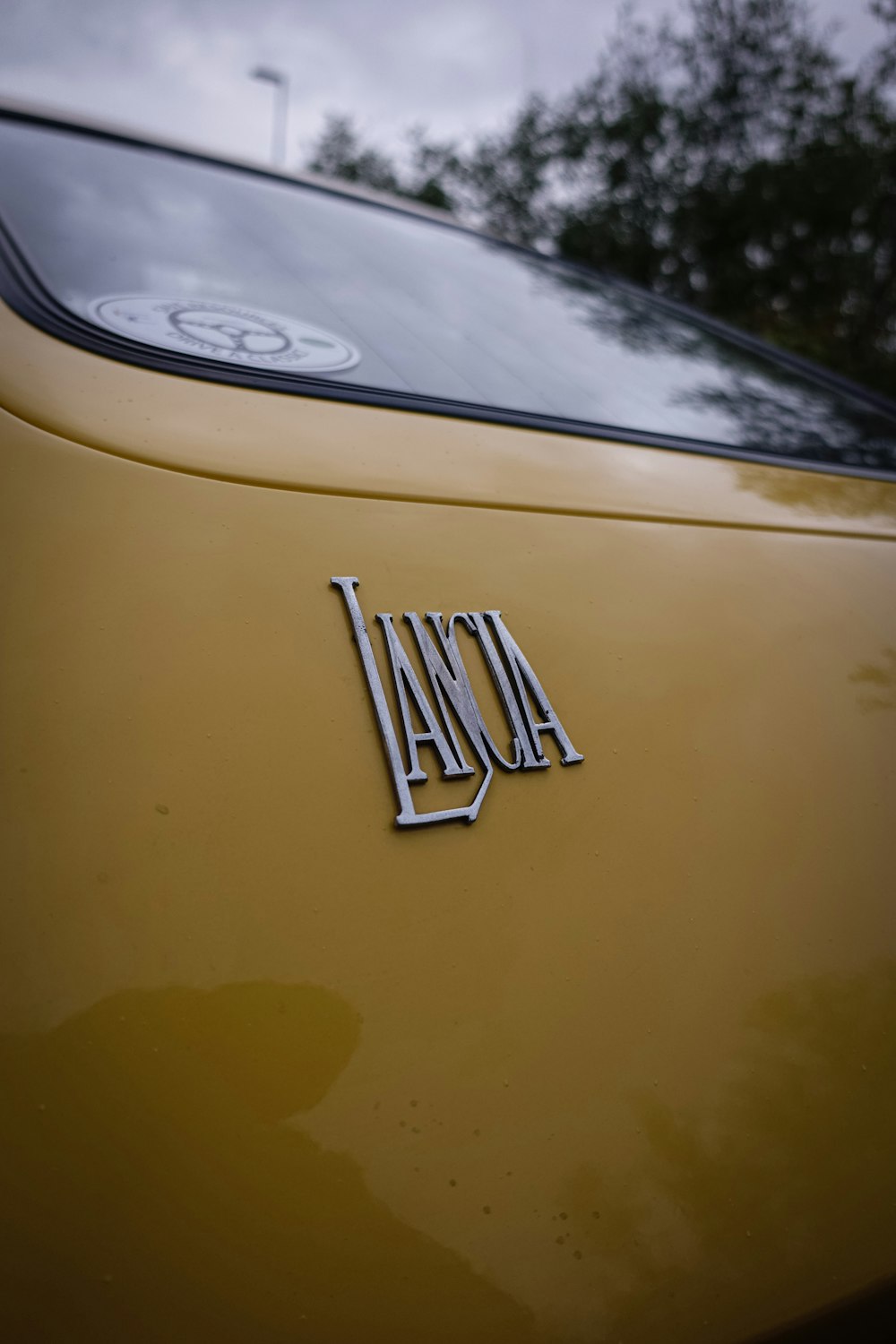 a close up of the front of a yellow car