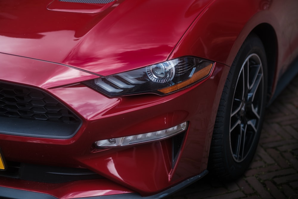 a close up of the front of a red sports car