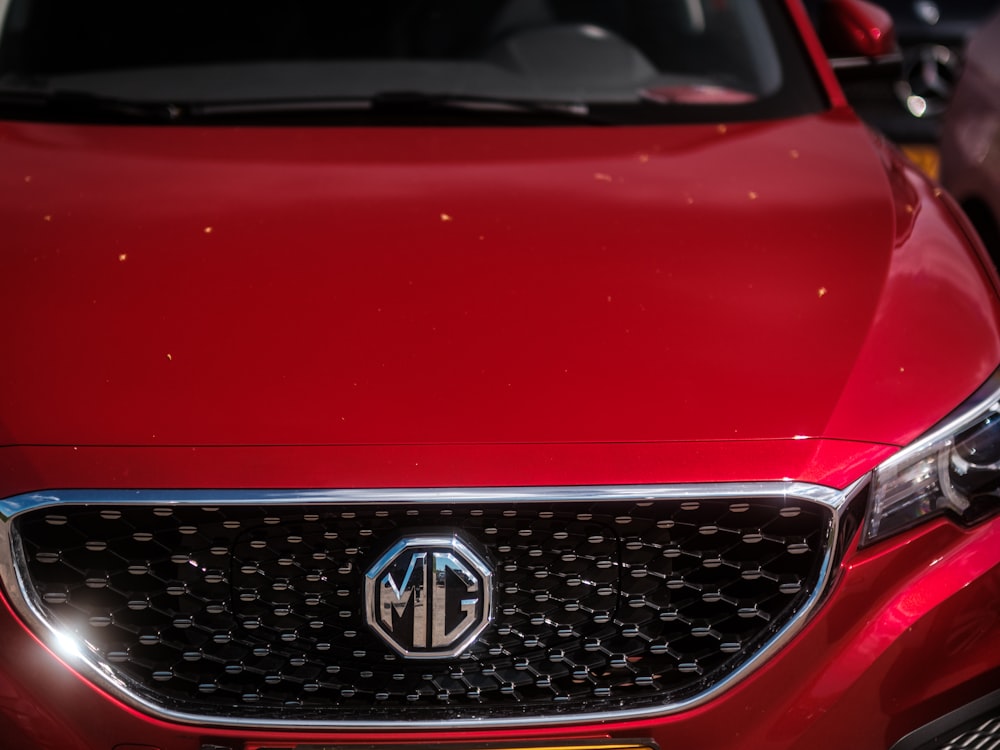 a close up of the front grille of a red car