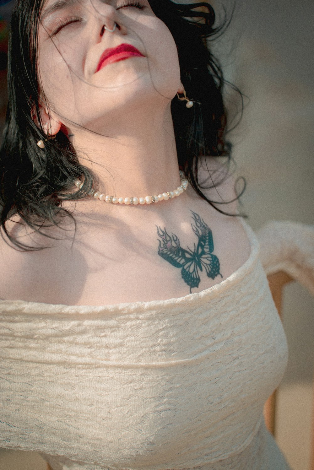 a woman with a bird tattoo on her chest