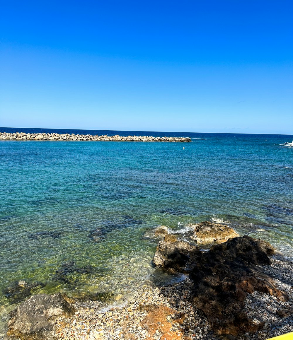 a view of the ocean from a rocky shore