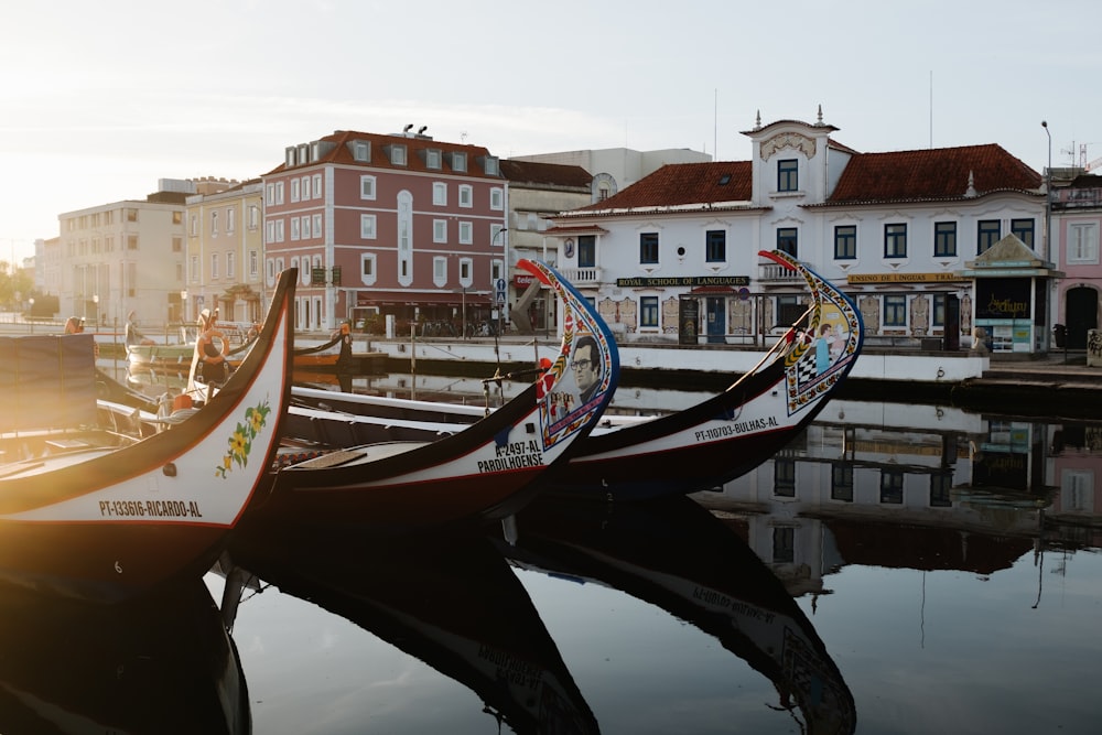 a row of boats sitting next to each other on a river