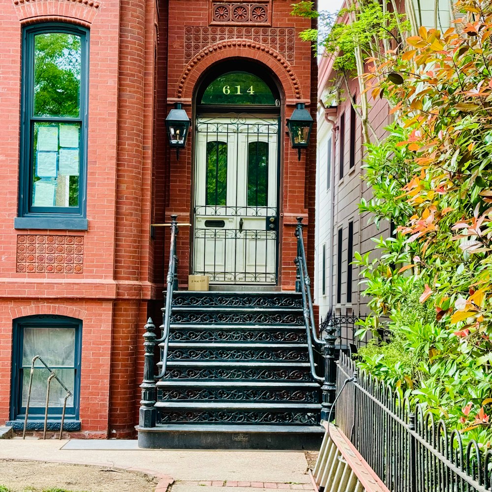 a red brick building with stairs leading up to the door