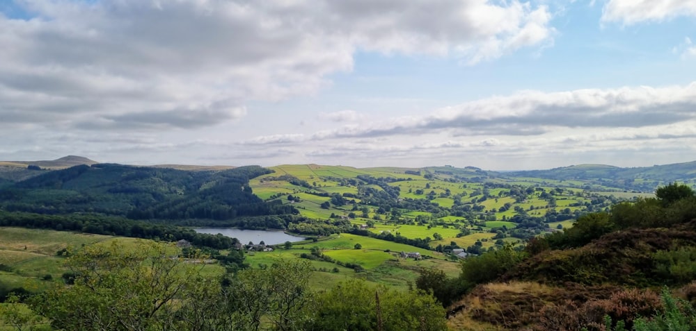 a view of a valley with a lake in the middle